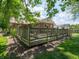 A spacious wooden back deck with an outdoor table and chairs and a view of the backyard at 10307 Wilson Rd, Brownsburg, IN 46112