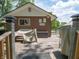 Cozy back deck with outdoor seating, grilling station, and outdoor decor under bright blue sky at 10307 Wilson Rd, Brownsburg, IN 46112