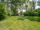 Expansive grassy back yard with a storage shed on the property at 10307 Wilson Rd, Brownsburg, IN 46112