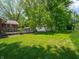 Expansive backyard featuring lush greenery, mature trees, and a charming wooden deck, ideal for Gathering gatherings at 10307 Wilson Rd, Brownsburg, IN 46112
