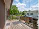 Exterior view of house showcasing a wooden deck, lawn, and backyard surroundings, offering an inviting outdoor living space at 10307 Wilson Rd, Brownsburg, IN 46112