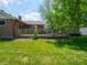 Spacious backyard with a well-kept lawn and a wooden deck, perfect for outdoor entertainment and relaxation at 10307 Wilson Rd, Brownsburg, IN 46112