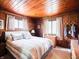 Cozy bedroom featuring wood paneling, comfortable furnishings, and soft natural light at 10307 Wilson Rd, Brownsburg, IN 46112