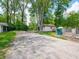 Long driveway with a spacious yard, shed, and lush greenery at 10307 Wilson Rd, Brownsburg, IN 46112