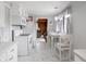 Bright white kitchen with modern countertops, appliances, and marble look flooring at 10307 Wilson Rd, Brownsburg, IN 46112