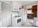 Bright white kitchen with modern countertops, appliances, and marble look flooring at 10307 Wilson Rd, Brownsburg, IN 46112