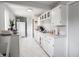 Fresh kitchen with white cabinets, ample counter space, and sleek, modern flooring at 10307 Wilson Rd, Brownsburg, IN 46112