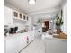 Bright white kitchen with modern countertops, appliances, and marble look flooring at 10307 Wilson Rd, Brownsburg, IN 46112