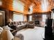 Comfortable living room with brick fireplace, wood paneled walls, and plush seating at 10307 Wilson Rd, Brownsburg, IN 46112