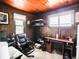 Home office featuring wood paneling, functional desk space, and modern fixtures at 10307 Wilson Rd, Brownsburg, IN 46112