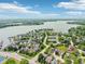 Expansive aerial view of a lakeside community with lush greenery, tennis courts, and waterfront access at 110 Avon Ln, Noblesville, IN 46062