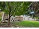 This home features a backyard with lush green grass and a cozy patio area with pergola at 110 Avon Ln, Noblesville, IN 46062