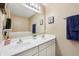 A bright, neutral bathroom features a large double vanity, mirror and lighting, and a separate tub at 110 Avon Ln, Noblesville, IN 46062
