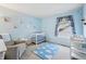 Bedroom with soft blue walls, a white crib, rocking chair and a window with patterned curtains at 110 Avon Ln, Noblesville, IN 46062