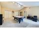 An open recreation room includes an air hockey table, a media center and TV, carpet, and extra storage at 110 Avon Ln, Noblesville, IN 46062