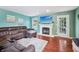 Spacious living room featuring a cozy fireplace, hardwood floors, and natural light, perfect for relaxation at 110 Avon Ln, Noblesville, IN 46062