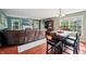 Living area showcasing a stone fireplace, large TV, sofa, bar, and dining table set, creating a cozy and inviting space at 110 Avon Ln, Noblesville, IN 46062
