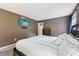 A spacious, carpeted main bedroom features a TV and views out of two large windows for plenty of natural light at 110 Avon Ln, Noblesville, IN 46062