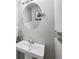 Cozy powder room with pedestal sink, round mirror, and modern lighting at 110 Avon Ln, Noblesville, IN 46062