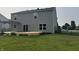 Back of house featuring a large deck, sliding glass doors, and a well-maintained lawn at 1287 Highland Lake Way, Brownsburg, IN 46112
