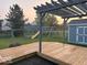 Backyard featuring a wooden deck, play set, a shed, black fence, and green lawn for outdoor enjoyment at 1287 Highland Lake Way, Brownsburg, IN 46112