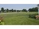 View of the spacious backyard surrounded by mature trees at 1287 Highland Lake Way, Brownsburg, IN 46112