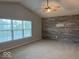 Bright bedroom with carpet flooring, neutral paint, large windows, and accent wooden wall at 1287 Highland Lake Way, Brownsburg, IN 46112