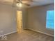 Carpeted bedroom with a ceiling fan and a window, offers a simple and comfortable living space at 1287 Highland Lake Way, Brownsburg, IN 46112