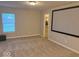 Versatile bonus room with plush carpeting, a large screen, and easy access to a walk-in closet at 1287 Highland Lake Way, Brownsburg, IN 46112