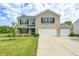 Charming two-story home featuring brick and siding, with a well-manicured lawn and two-car garage at 1287 Highland Lake Way, Brownsburg, IN 46112