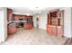 Spacious kitchen with a view into the dining area, dark cabinets, island and stainless steel appliances at 1287 Highland Lake Way, Brownsburg, IN 46112