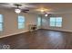 Expansive living room with hardwood floors, neutral paint, many windows, and a cozy fireplace at 1287 Highland Lake Way, Brownsburg, IN 46112