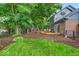 Expansive backyard featuring lush greenery, a tiered deck, and outdoor seating areas at 12961 Limberlost Dr, Carmel, IN 46033