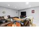 Finished basement features a leather sectional, entertainment area, and hardwood table at 12961 Limberlost Dr, Carmel, IN 46033