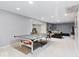 Finished basement features a ping pong table, work out area, and lounge seating at 12961 Limberlost Dr, Carmel, IN 46033