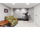 Finished basement features a workout area with a treadmill and living room seating at 12961 Limberlost Dr, Carmel, IN 46033