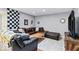 Finished basement offers a cozy sectional, entertainment area, and stylish decor at 12961 Limberlost Dr, Carmel, IN 46033