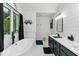 Modern bathroom featuring a soaking tub, sleek vanity, and a window with black curtains at 12961 Limberlost Dr, Carmel, IN 46033