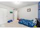 Cozy bedroom with neutral walls and carpet, featuring a closet and a playful blue car toy at 12961 Limberlost Dr, Carmel, IN 46033