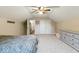 Well-lit bedroom with neutral walls, carpet, a ceiling fan, and double closet doors at 12961 Limberlost Dr, Carmel, IN 46033