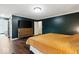 Bright bedroom with hardwood floors, king bed, and a view into the bathroom and closet at 12961 Limberlost Dr, Carmel, IN 46033