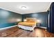 Spacious bedroom featuring hardwood floors, a king-size bed, and ample natural light at 12961 Limberlost Dr, Carmel, IN 46033