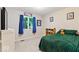 Comfortable bedroom with a green quilt, window with blue curtains, and a cozy atmosphere at 12961 Limberlost Dr, Carmel, IN 46033