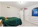 Well-lit bedroom featuring a plush green quilt and a view of the closet and doorway at 12961 Limberlost Dr, Carmel, IN 46033