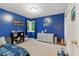 Charming bedroom featuring blue walls, plush carpet, and a bay window for ample natural light at 12961 Limberlost Dr, Carmel, IN 46033