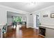 Open concept dining room showcasing hardwood floors, ample natural light, and seamless flow to the kitchen at 12961 Limberlost Dr, Carmel, IN 46033