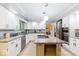 Bright kitchen with stainless appliances, granite countertops, eat-in island, and lots of cabinet space at 12961 Limberlost Dr, Carmel, IN 46033