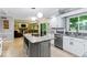 Open concept kitchen featuring a center island, granite countertops, stainless appliances, and natural light at 12961 Limberlost Dr, Carmel, IN 46033