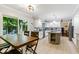 Bright eat-in kitchen with sliding glass doors to the backyard, light cabinets, and granite countertops at 12961 Limberlost Dr, Carmel, IN 46033