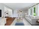 Bright living room featuring hardwood floors, a large window, and tasteful decor at 12961 Limberlost Dr, Carmel, IN 46033